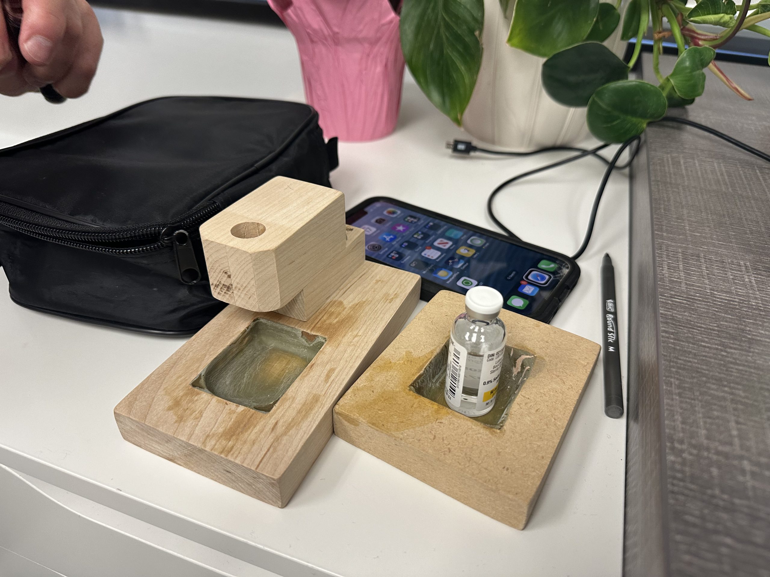 Custom wooden tactile pod-filling station, designed to prevent misalignment and dosing errors.